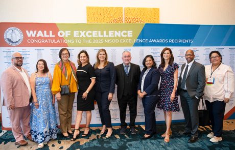 2025EA3 Photo showing a group of 2025 Excellence Awards Recipients in front of the Wall of Excellence.